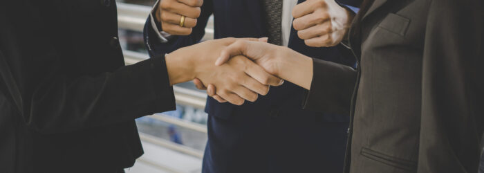 Business people shaking hands, finishing up meeting deals. Business concept.